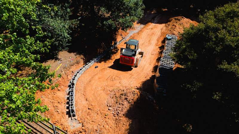 aerial view of the first courses of retaining wall block going in along the excavated slope